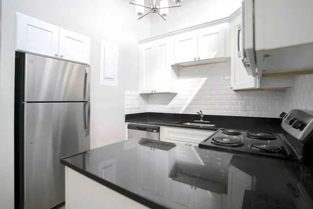 a kitchen with a refrigerator and a sink