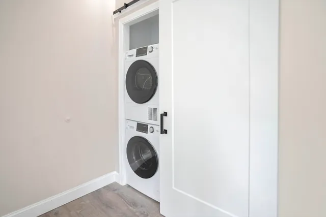 a view of a hallway with washer and dryer