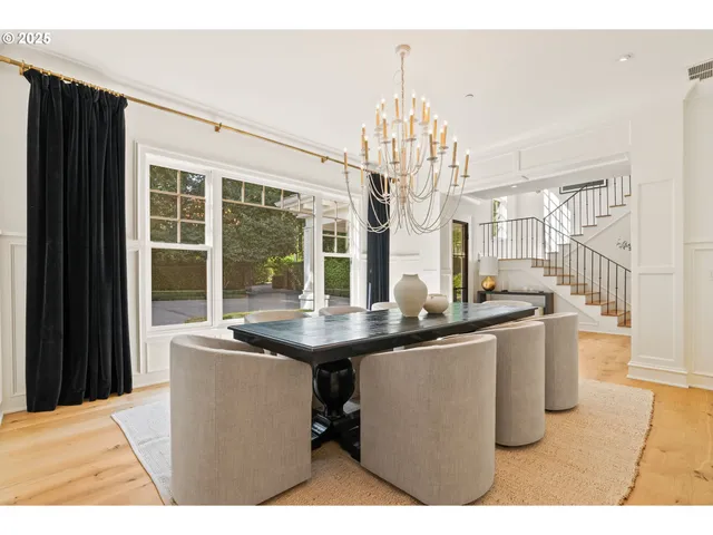 a dining room with furniture a chandelier and a rug