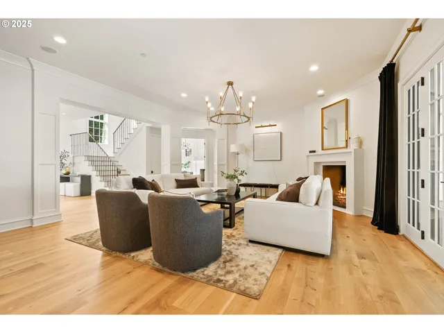 a living room with furniture a large window and kitchen view