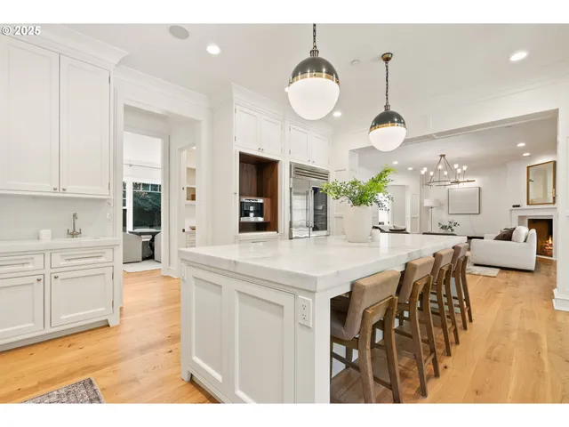 a large kitchen with a table and chairs