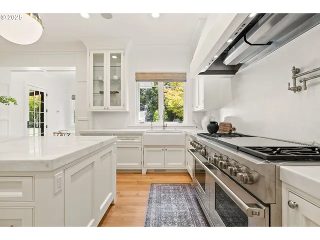 a kitchen with a stove a sink and a wooden cabinets