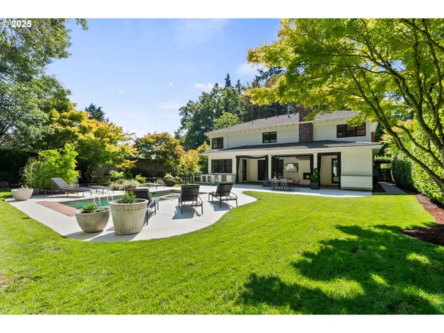 a view of a house with backyard sitting area and garden