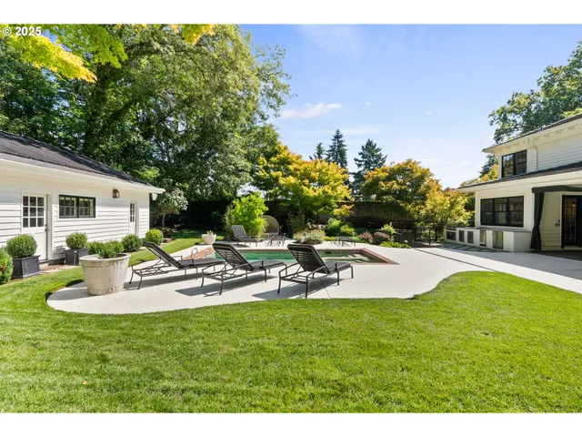 a view of a house with backyard and sitting area