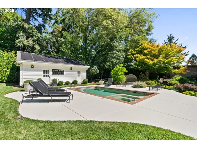 a view of a house with backyard and sitting area