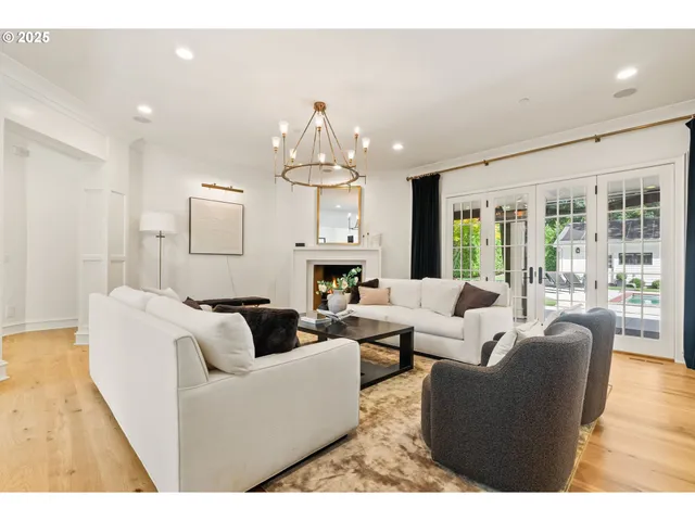 a living room with furniture fireplace and a large window