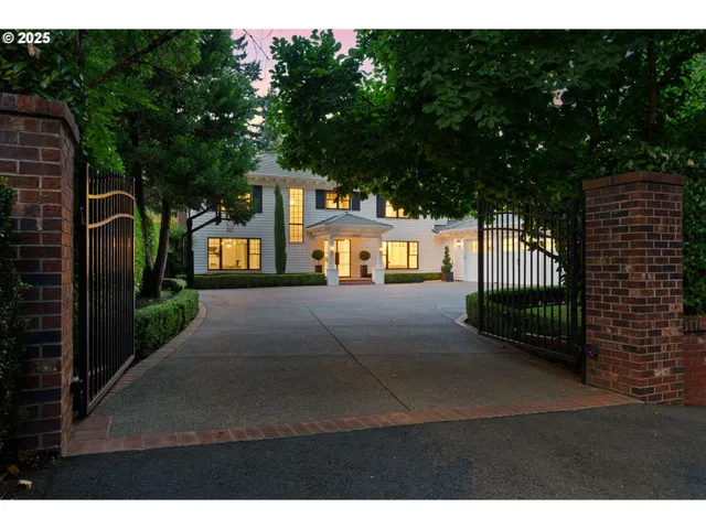 a view of a street with brick wall and potted plants