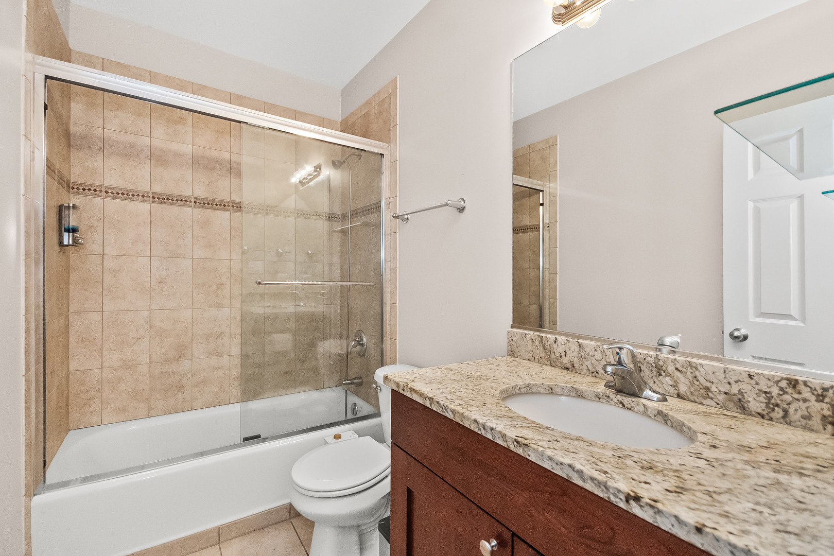 3986 South Drexel Boulevard, Unit 3N Chicago, IL 60653 - Photo 11 of 16 a bathroom with a granite countertop sink toilet and shower