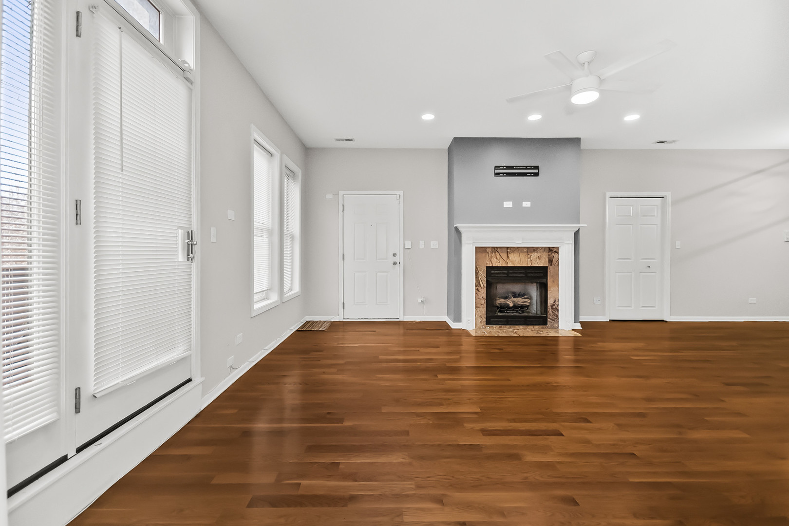 3986 South Drexel Boulevard, Unit 3N Chicago, IL 60653 - Photo 3 of 16 an empty room with wooden floor fireplace and window