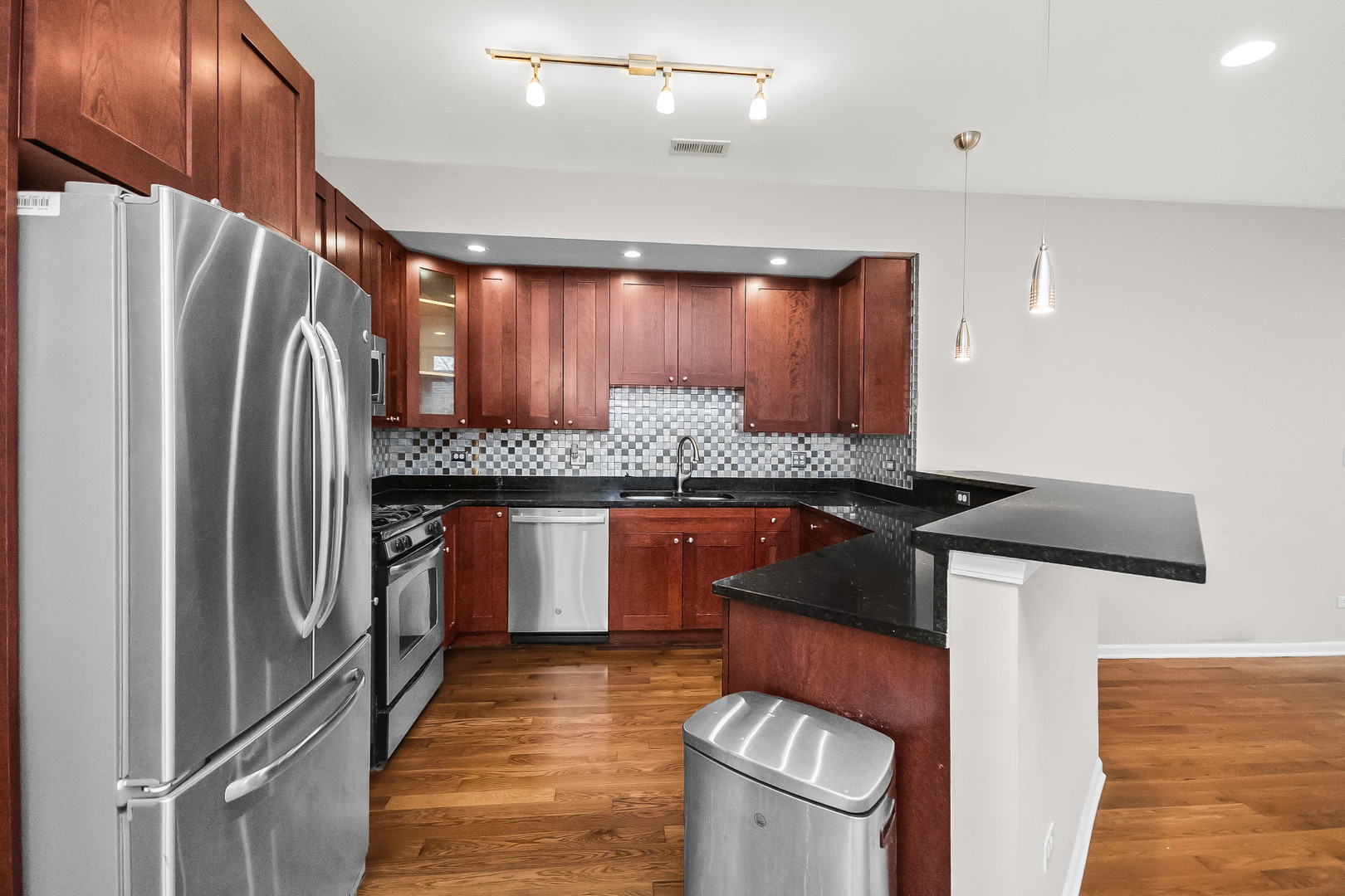 3986 South Drexel Boulevard, Unit 3N Chicago, IL 60653 - Photo 6 of 16 a kitchen with stainless steel appliances granite countertop a refrigerator and a stove
