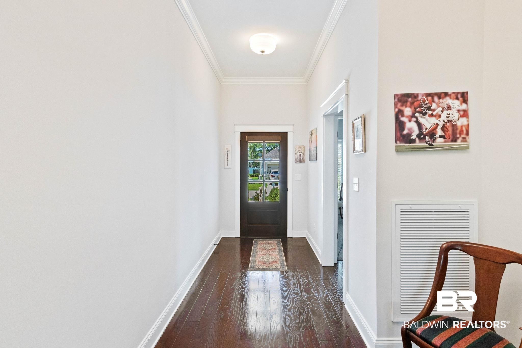 192 Mark Twain Loop Foley, AL 36535 - Photo 3 of 42 Doorway to outside with dark hardwood / wood-style floors and ornamental molding