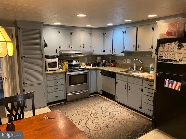5152 Hiffletrayer Road Green Lane, PA 18054 - Photo 6 of 24 a kitchen with granite countertop a stove top oven sink and cabinets