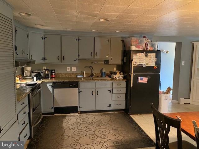 5152 Hiffletrayer Road Green Lane, PA 18054 - Photo 7 of 24 a kitchen with granite countertop a refrigerator stove oven and white cabinets with wooden floor