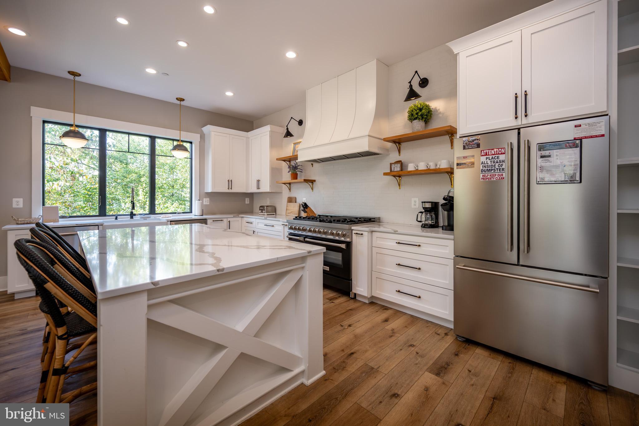 152 Ridge Run Road McHenry, MD 21541 - Photo 11 of 100 a kitchen with kitchen island white cabinets and stainless steel appliances