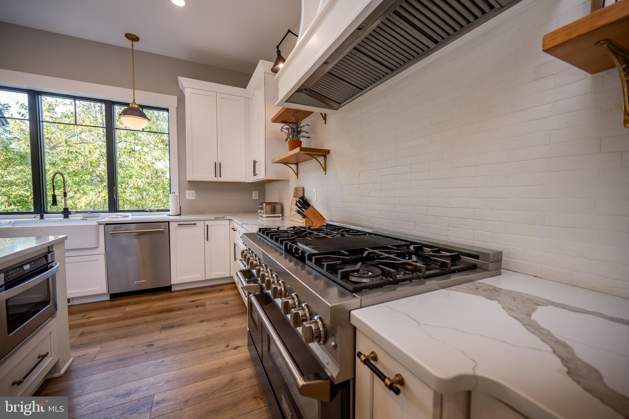 152 Ridge Run Road McHenry, MD 21541 - Photo 13 of 100 a kitchen with a stove a sink and a microwave