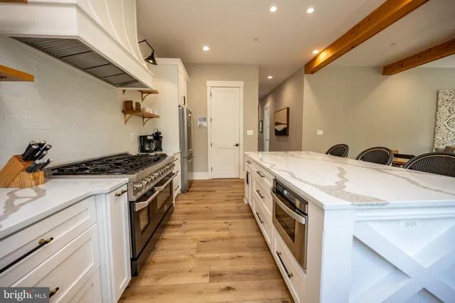 a view of staircase with wooden floor and a rug
