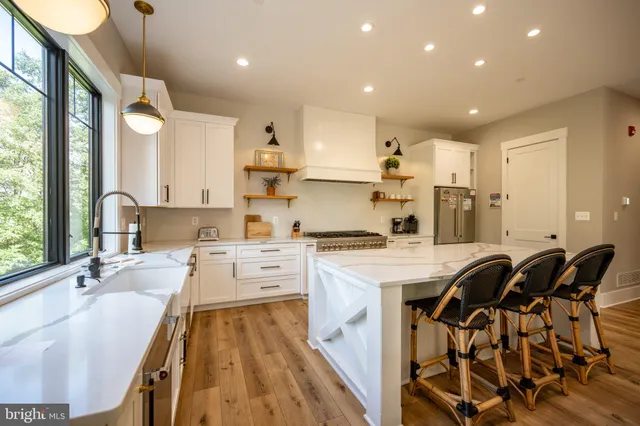 a balcony with wooden floor and outdoor seating