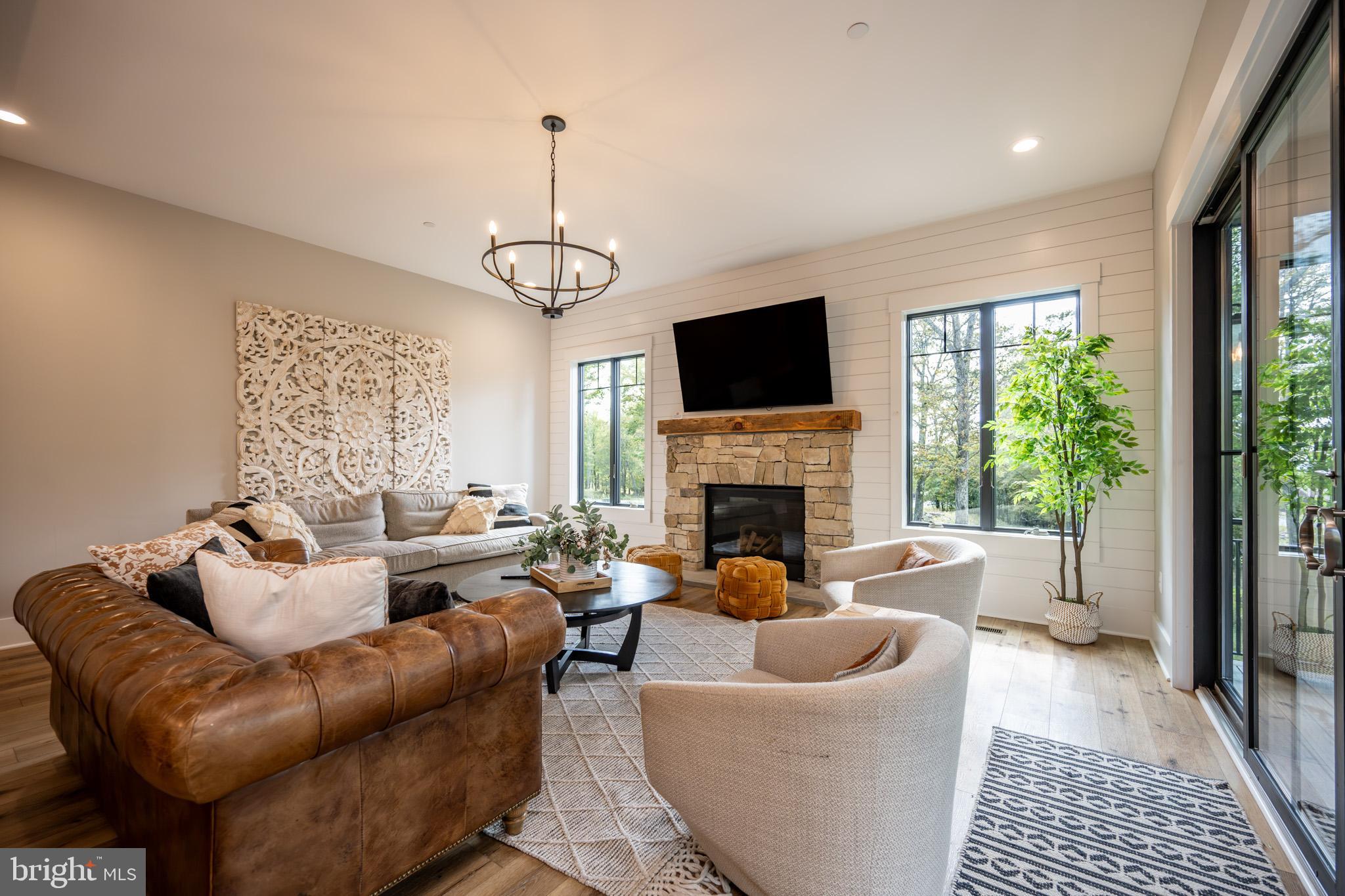152 Ridge Run Road McHenry, MD 21541 - Photo 20 of 100 a living room with furniture a flat screen tv and a fireplace