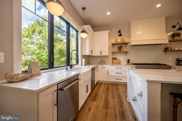 a bathroom with a sink toilet mirror and shower