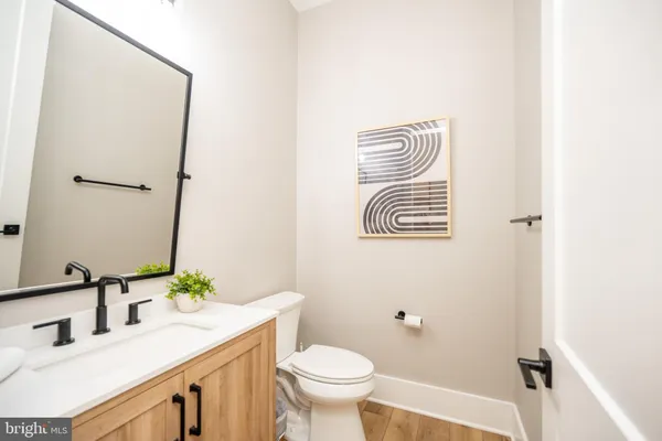 a bathroom with a double vanity sink toilet and mirror