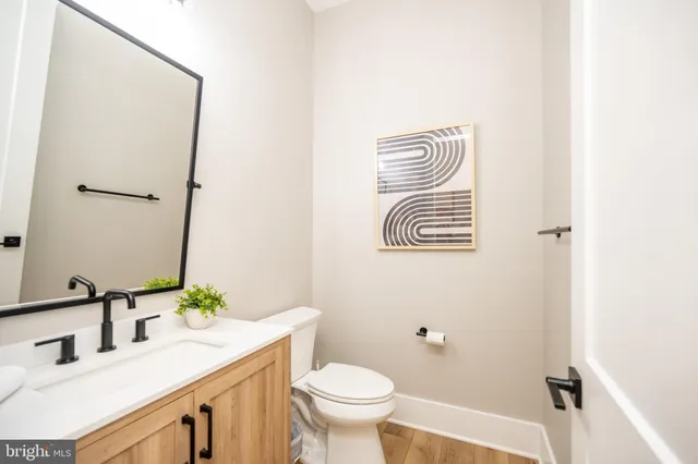 a bathroom with a double vanity sink toilet and mirror