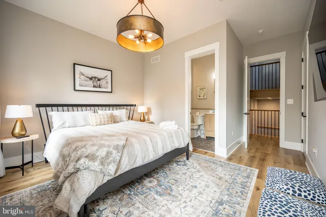 a spacious bedroom with a bed and a table