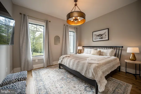 a bathroom with a granite countertop toilet a sink a mirror and shower