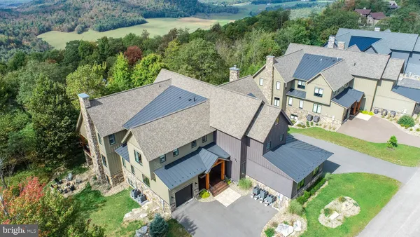 a kitchen with kitchen island white cabinets and stainless steel appliances