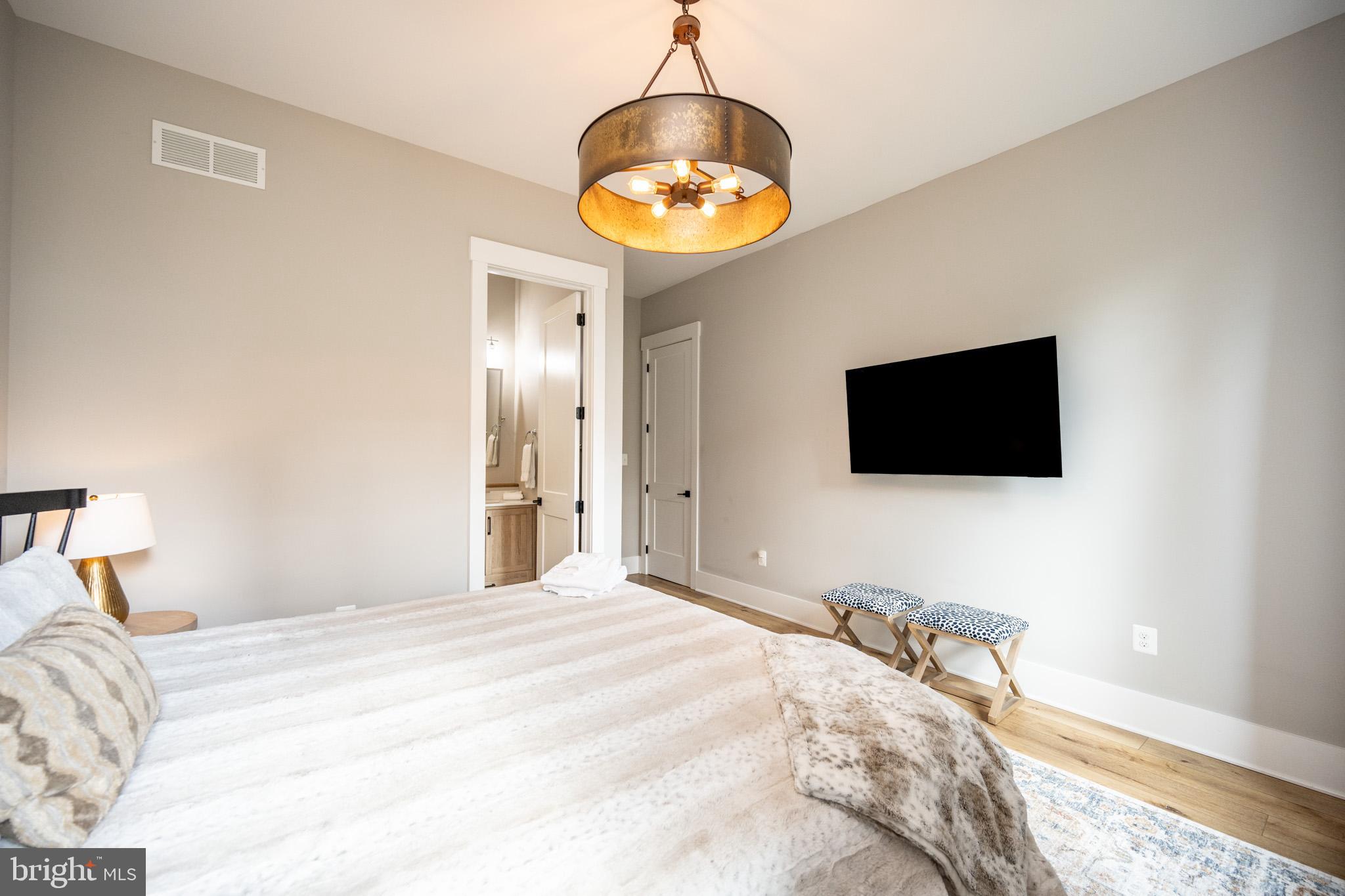 152 Ridge Run Road McHenry, MD 21541 - Photo 41 of 100 a bedroom with a bed and a flat screen tv