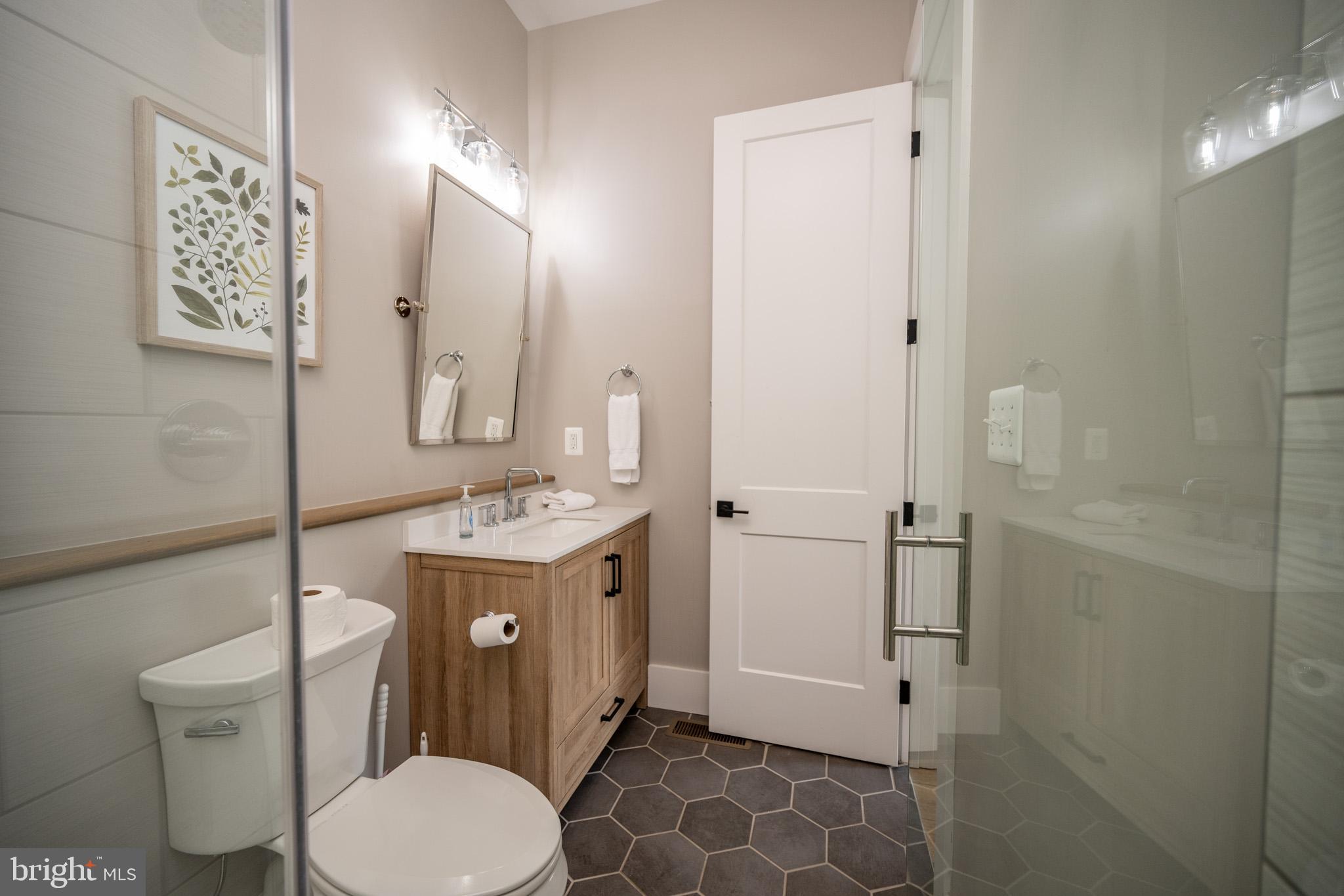 152 Ridge Run Road McHenry, MD 21541 - Photo 47 of 100 a bathroom with a sink toilet mirror and shower