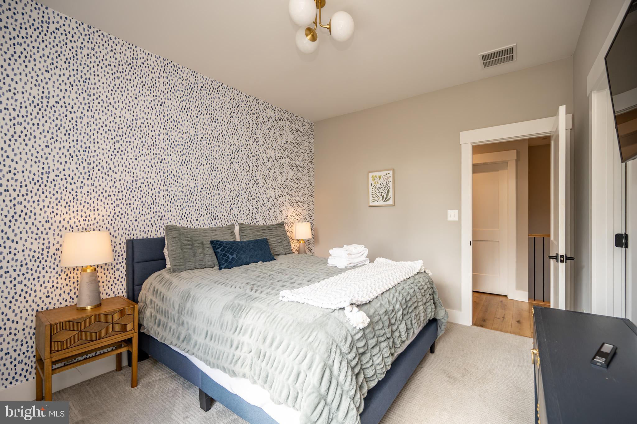 152 Ridge Run Road McHenry, MD 21541 - Photo 56 of 100 a bedroom with a bed and a lamp on table