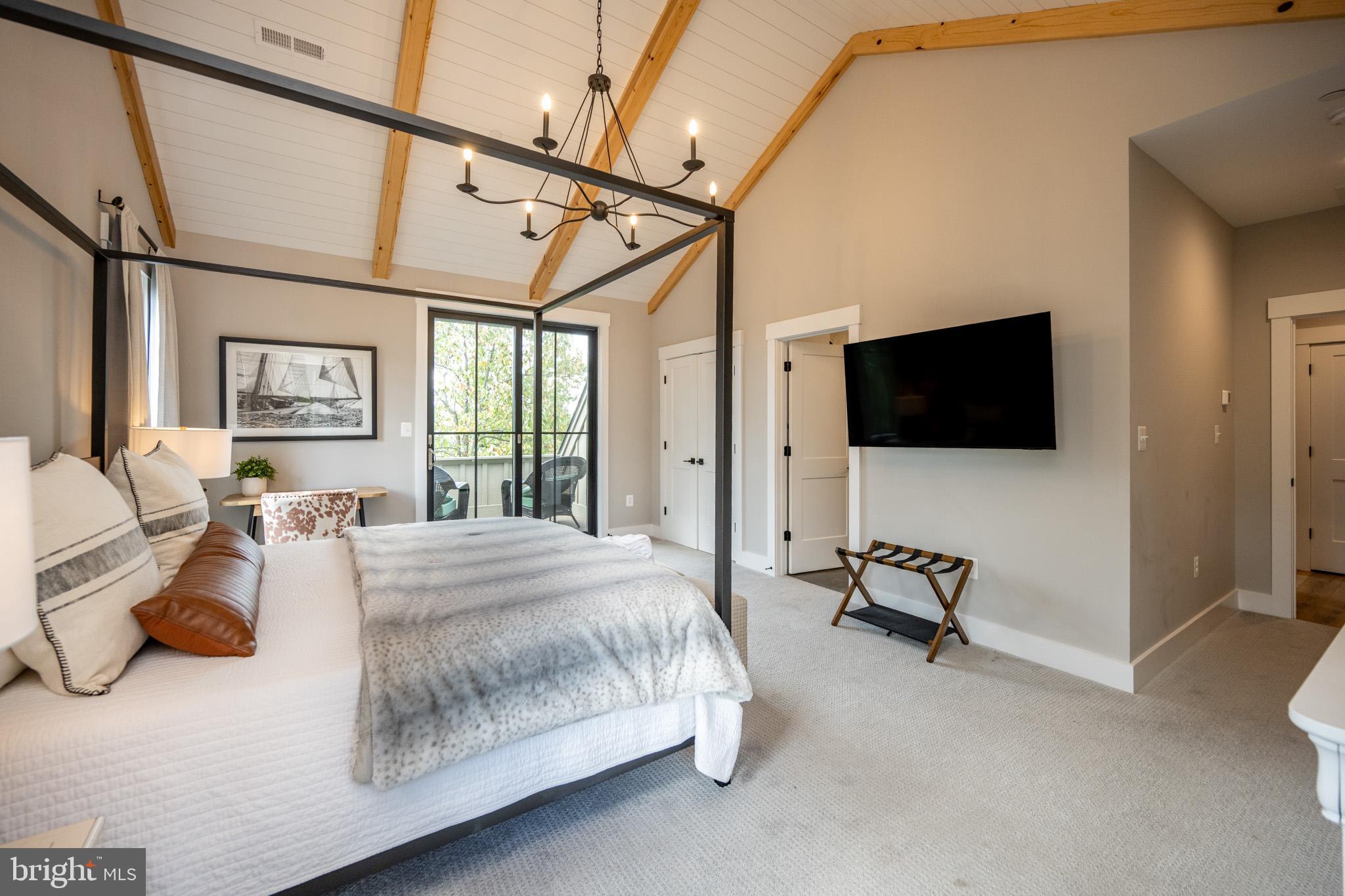 152 Ridge Run Road McHenry, MD 21541 - Photo 61 of 100 a spacious bedroom with a bed and a flat screen tv