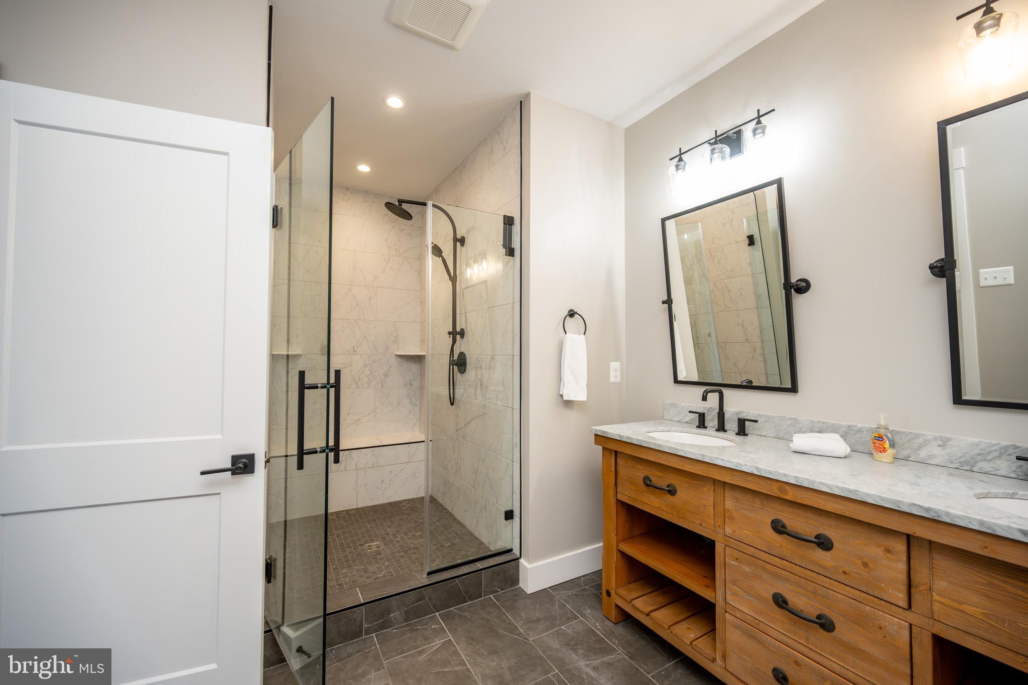 152 Ridge Run Road McHenry, MD 21541 - Photo 63 of 100 a bathroom with a double vanity sink mirror double and shower