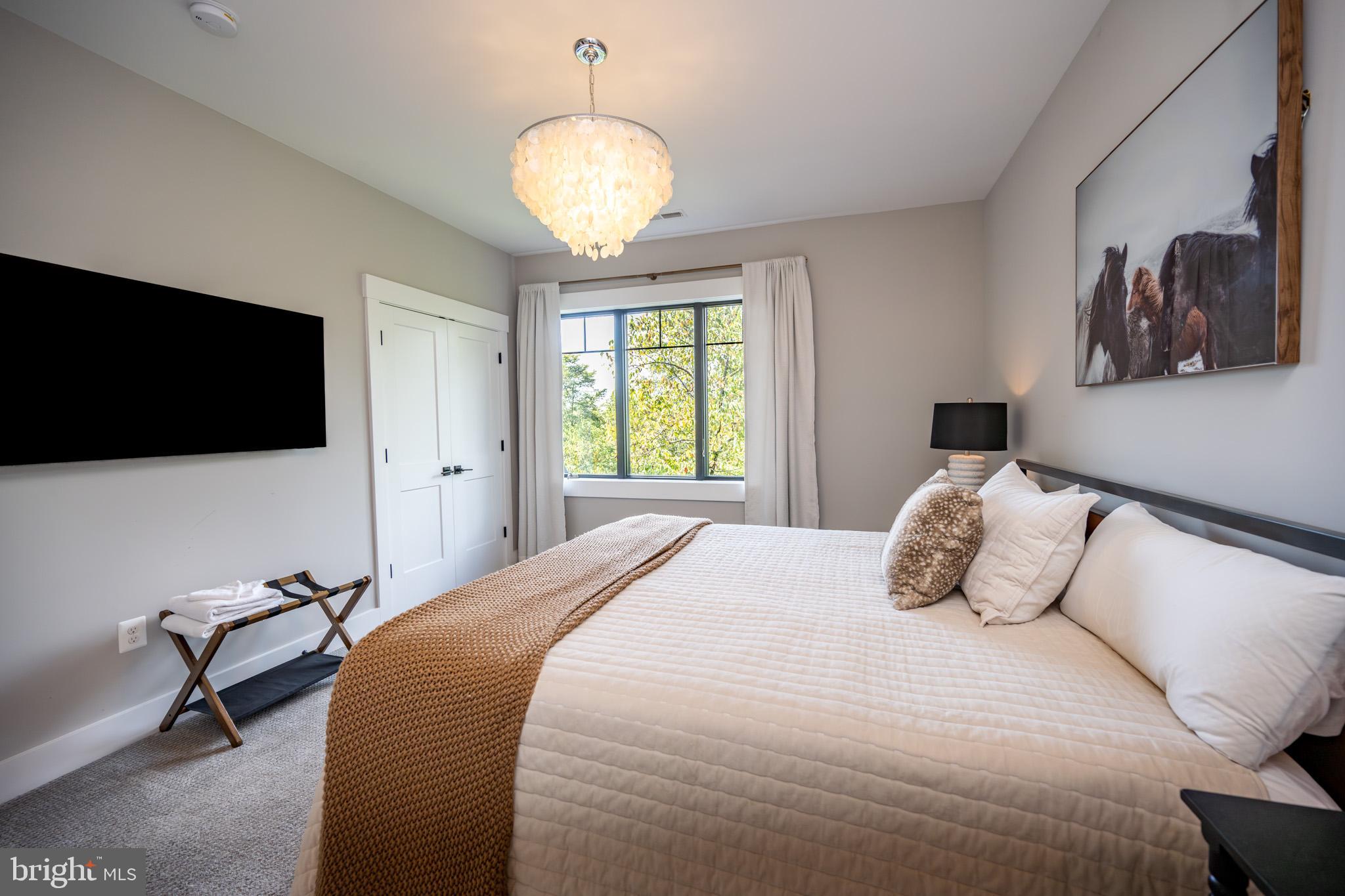 152 Ridge Run Road McHenry, MD 21541 - Photo 64 of 100 a bedroom with a bed and a flat screen tv