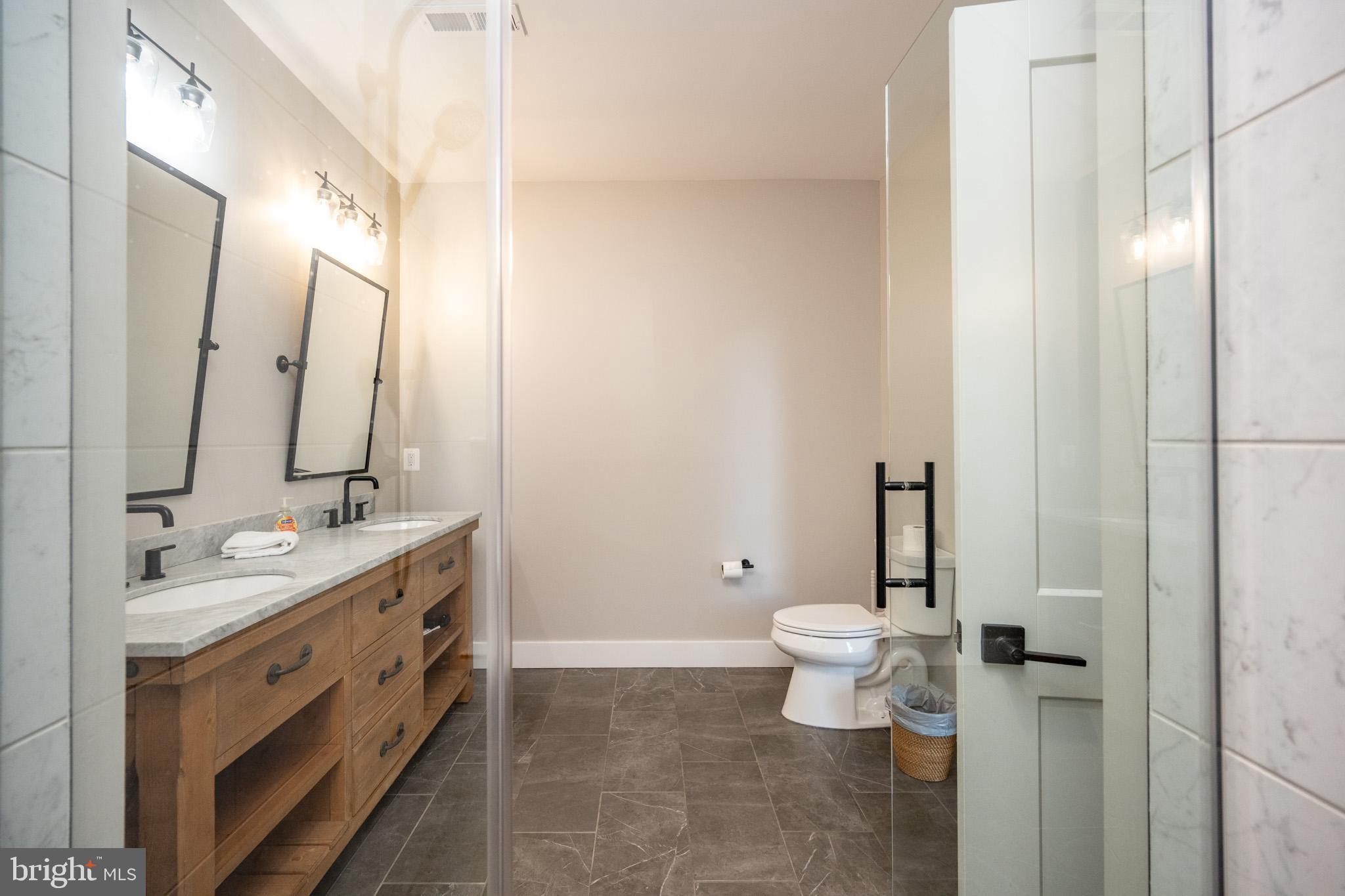 152 Ridge Run Road McHenry, MD 21541 - Photo 67 of 100 a bathroom with a double vanity sink toilet and mirror