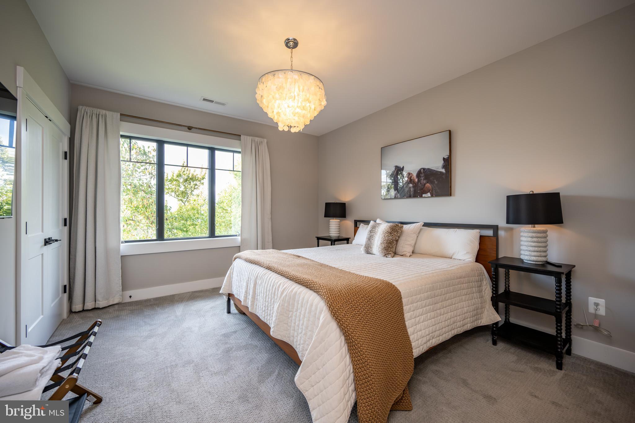 152 Ridge Run Road McHenry, MD 21541 - Photo 71 of 100 a spacious bedroom with a bed and a table