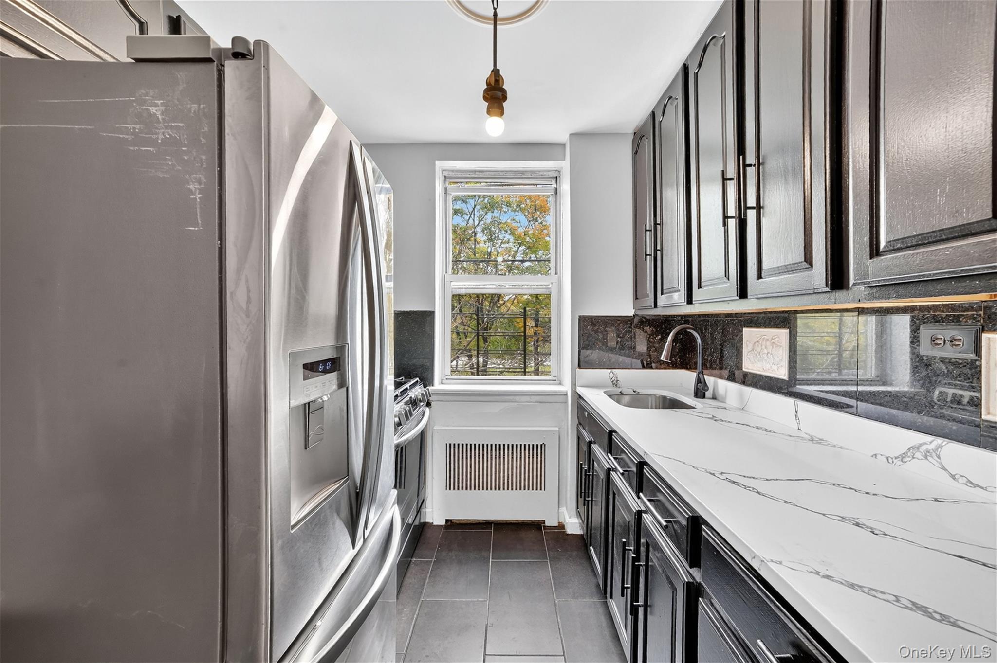4295 Webster Avenue, Unit 1D Bronx, NY 10470 - Photo 11 of 21 a kitchen with stainless steel appliances granite countertop a refrigerator and a sink