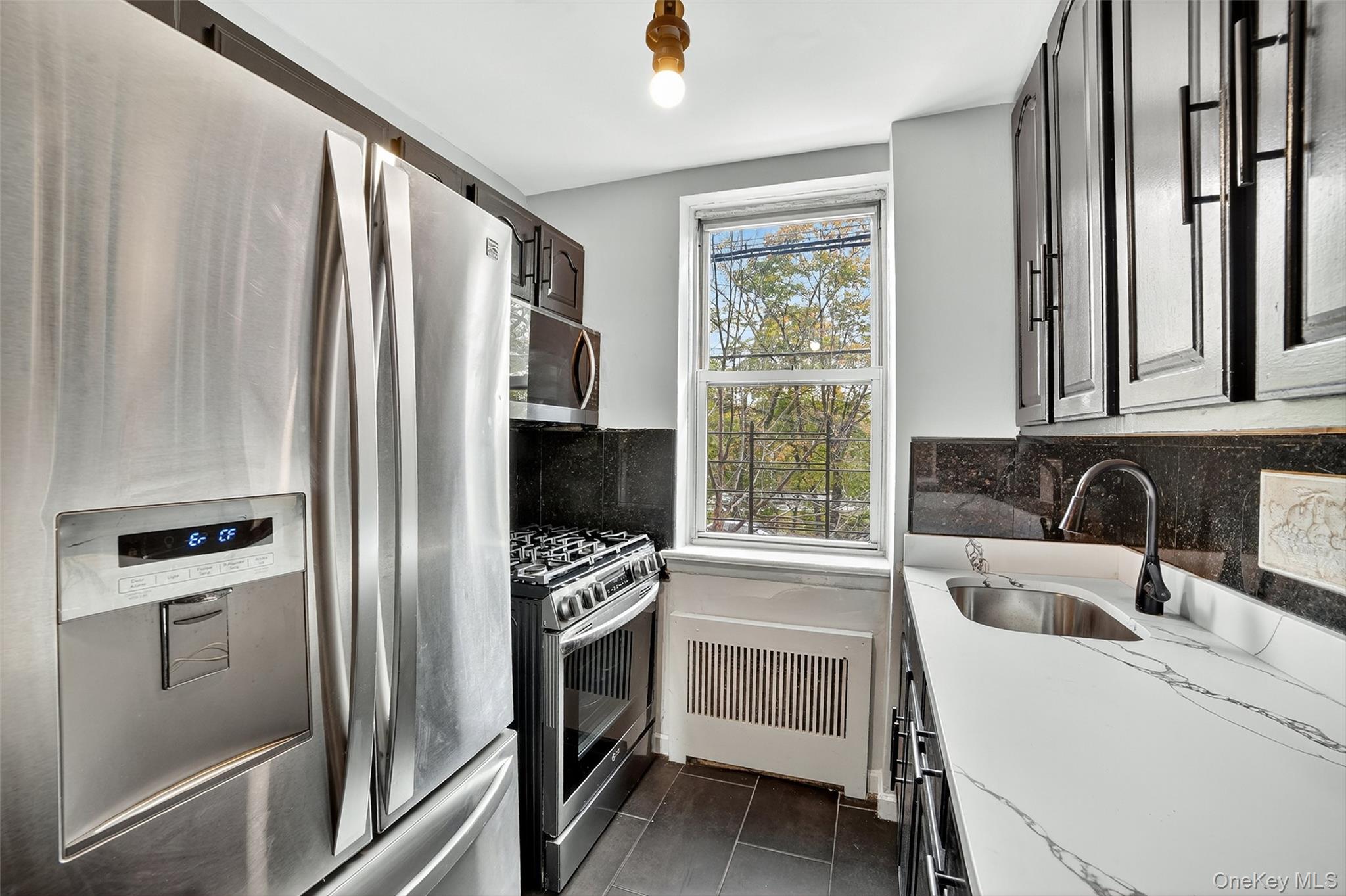 4295 Webster Avenue, Unit 1D Bronx, NY 10470 - Photo 13 of 21 a kitchen with a refrigerator and a sink
