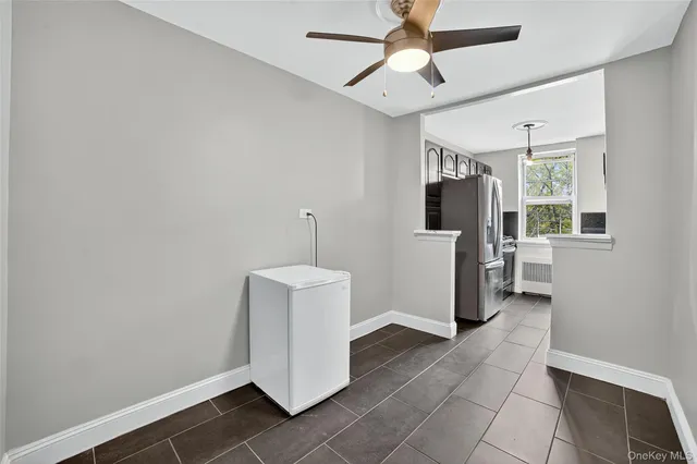 a view of a hallway with entryway and chandelier