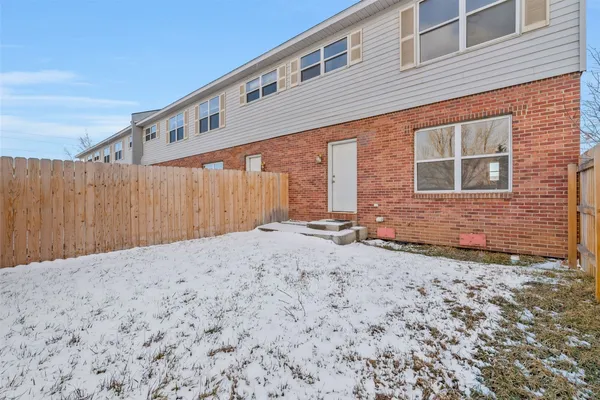 a backyard of a house with wooden fence