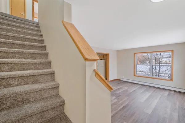 a view of entryway with wooden floor and stairs
