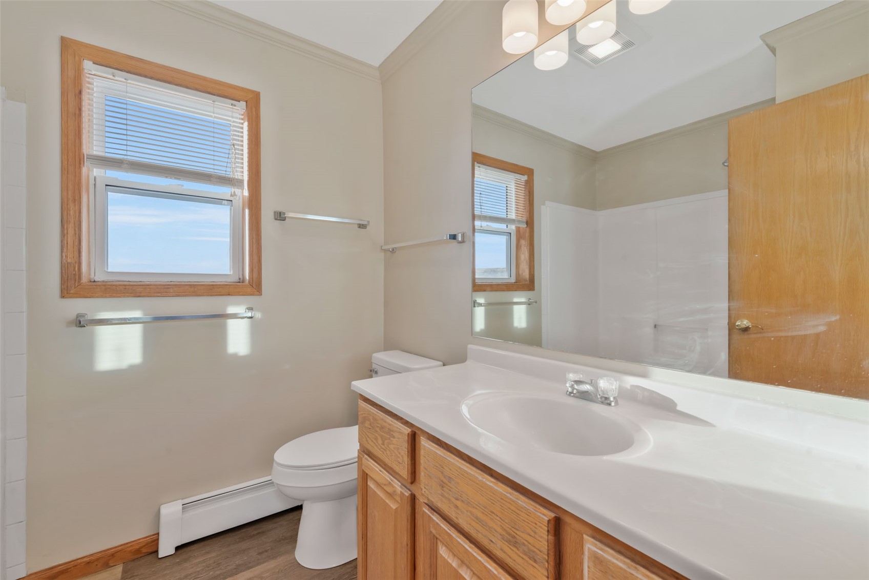 401 South 3rd Street, Unit 401 Hayden, CO 81639 - Photo 19 of 38 a bathroom with a toilet a sink a mirror and a window