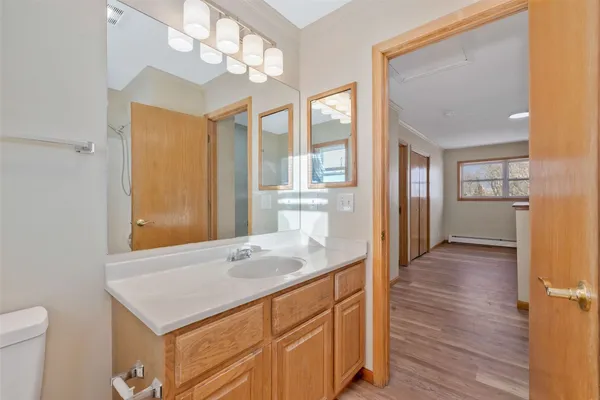 a bathroom with a sink a mirror and a toilet