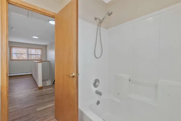 a bathroom with a bathtub and shower