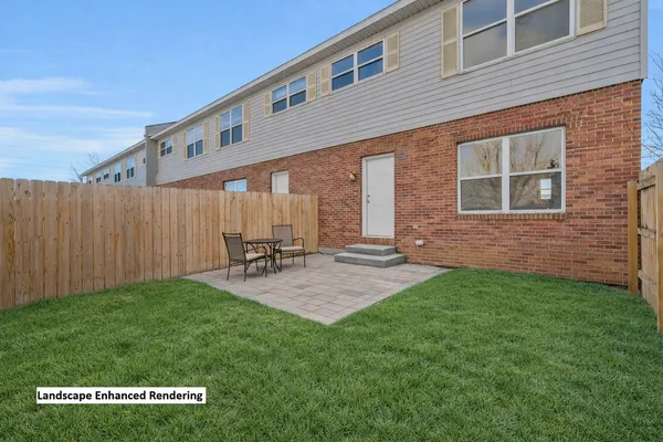 a backyard of a house with table and chairs