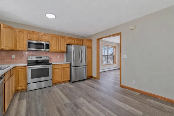 a kitchen with stainless steel appliances a refrigerator and a stove top oven