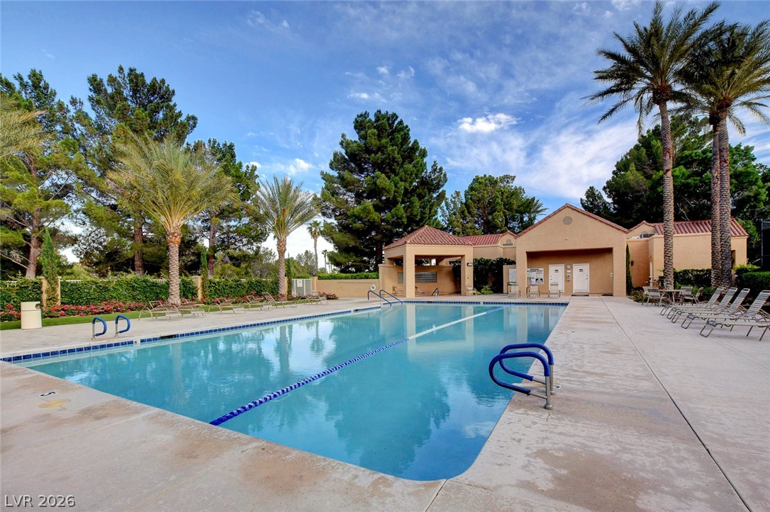7995 Rio Rico Drive Las Vegas, NV 89113 - Photo 88 of 92 Lush landscaping and towering palm trees frame this inviting community swimming pool and amenity building.
