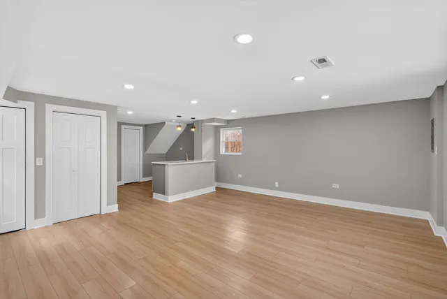 a view of a kitchen with wooden floor and stairs