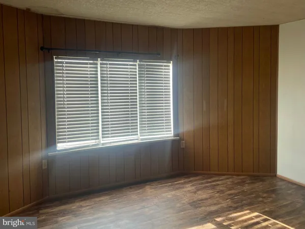 a view of a hallway with wooden walls