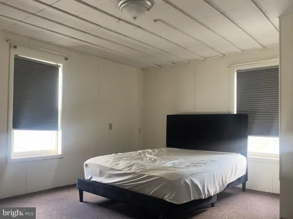 a bedroom with a bed and a mirror